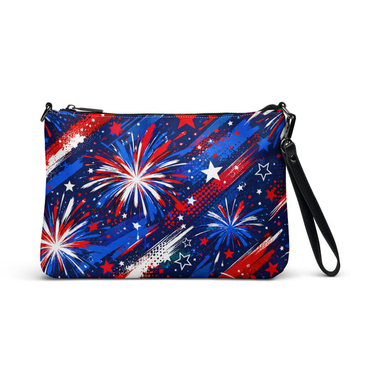 Star-Spangled Sky all-over print crossbody bag with red, white, and blue fireworks bursts and stars on deep navy, black hardware and removable strap