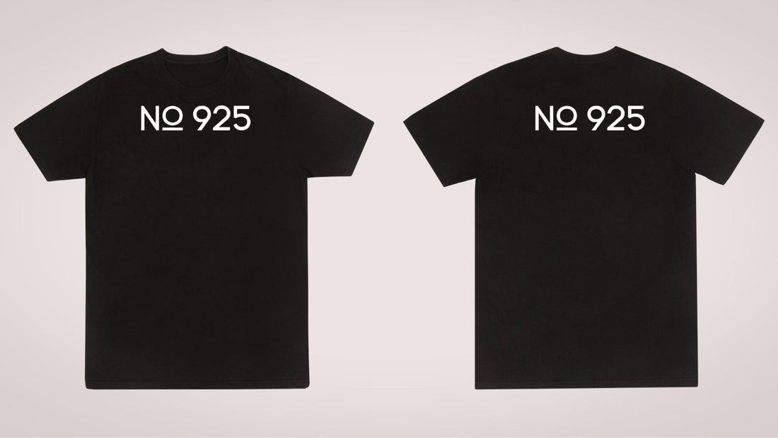 Front and back views of a plain black short-sleeve t-shirt displayed side-by-side against a light gray background. Both views feature the text "No. 925" printed in a clean, white, sans-serif font across the upper chest and upper back.