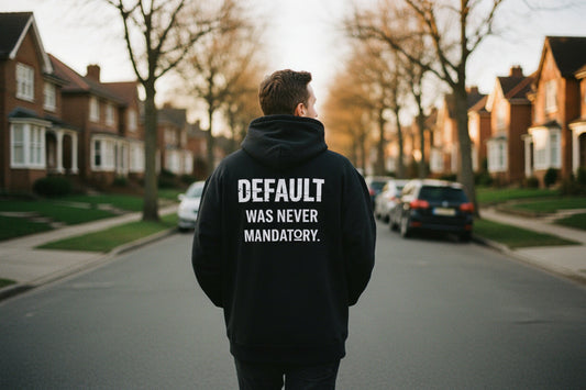 Person walking down a brick alley wearing the No 925 Default Was Never Mandatory oversized graphic hoodie