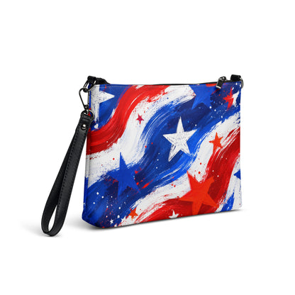 Stars and Stripes all-over print crossbody bag in painted red, white, and blue brushstrokes with scattered stars, black hardware and removable strap