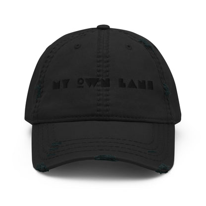 My Own Lane distressed dad hat in black, front view showing black on black geometric MY OWN LANE embroidery across front panel, distressed brim and crown, low profile unstructured fit.
