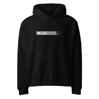 Unsubscribe wordmark dissolving into pixels on a black oversized graphic hoodie