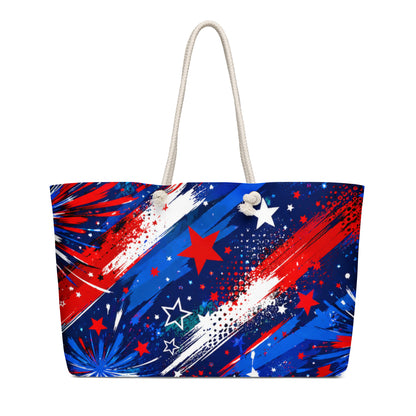 Star-Spangled Sky all-over print oversized weekender tote with red, white, and blue fireworks bursts and stars on deep navy and cream rope handles