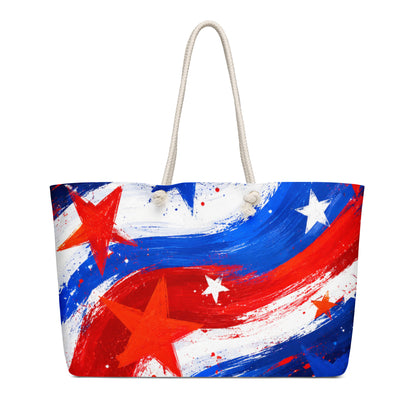 Stars and Stripes all-over print oversized weekender tote in painted red, white, and blue brushstrokes with scattered stars and cream rope handles