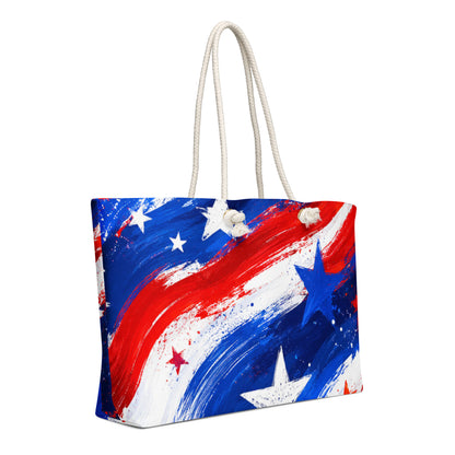 Stars and Stripes all-over print oversized weekender tote in painted red, white, and blue brushstrokes with scattered stars and cream rope handles