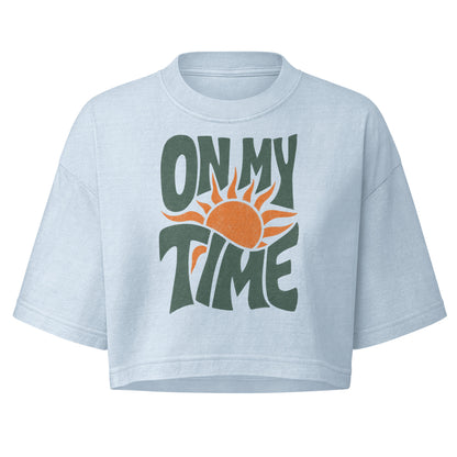 On My Time garment dye cropped tee with ON MY TIME in dark green retro lettering wrapped around an orange rising sun
