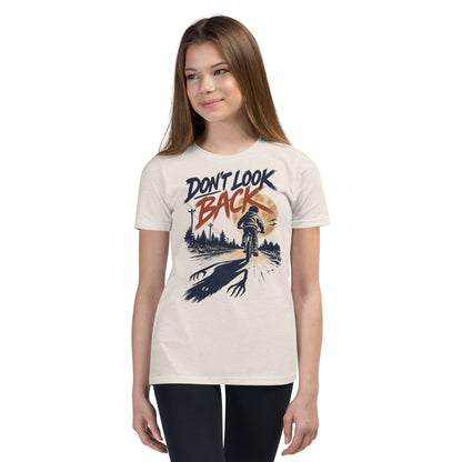 Don't Look Back youth t-shirt with a child riding a bicycle at sunset while a long clawed shadow follows on the road in heather dust, front view
