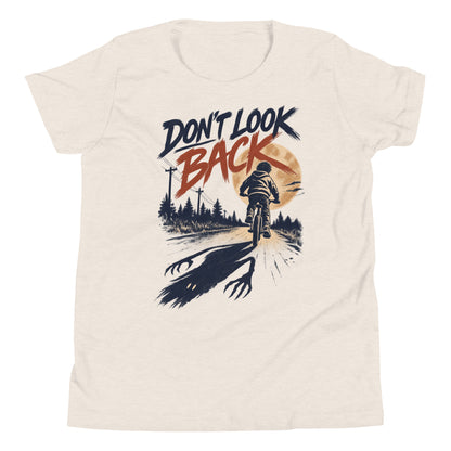 Don't Look Back youth t-shirt with a child riding a bicycle at sunset while a long clawed shadow follows on the road in heather dust, front view