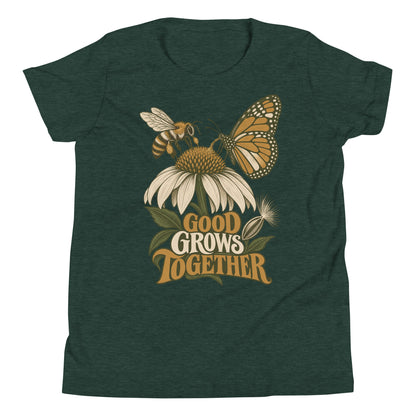 Good Grows Together Youth T-Shirt, front view with a bee and orange butterfly visiting a flower above GOOD GROWS TOGETHER lettering
