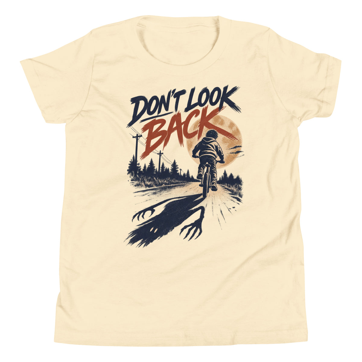 Don't Look Back youth t-shirt with a child riding a bicycle at sunset while a long clawed shadow follows on the road in natural, front view
