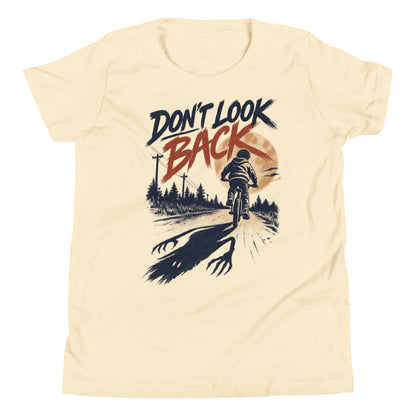 Don't Look Back youth t-shirt with a child riding a bicycle at sunset while a long clawed shadow follows on the road in natural, front view